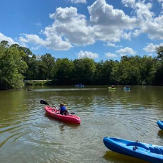 kayakers on the river in a red and blue kayak