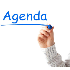 a hand writing the word agenda in blue