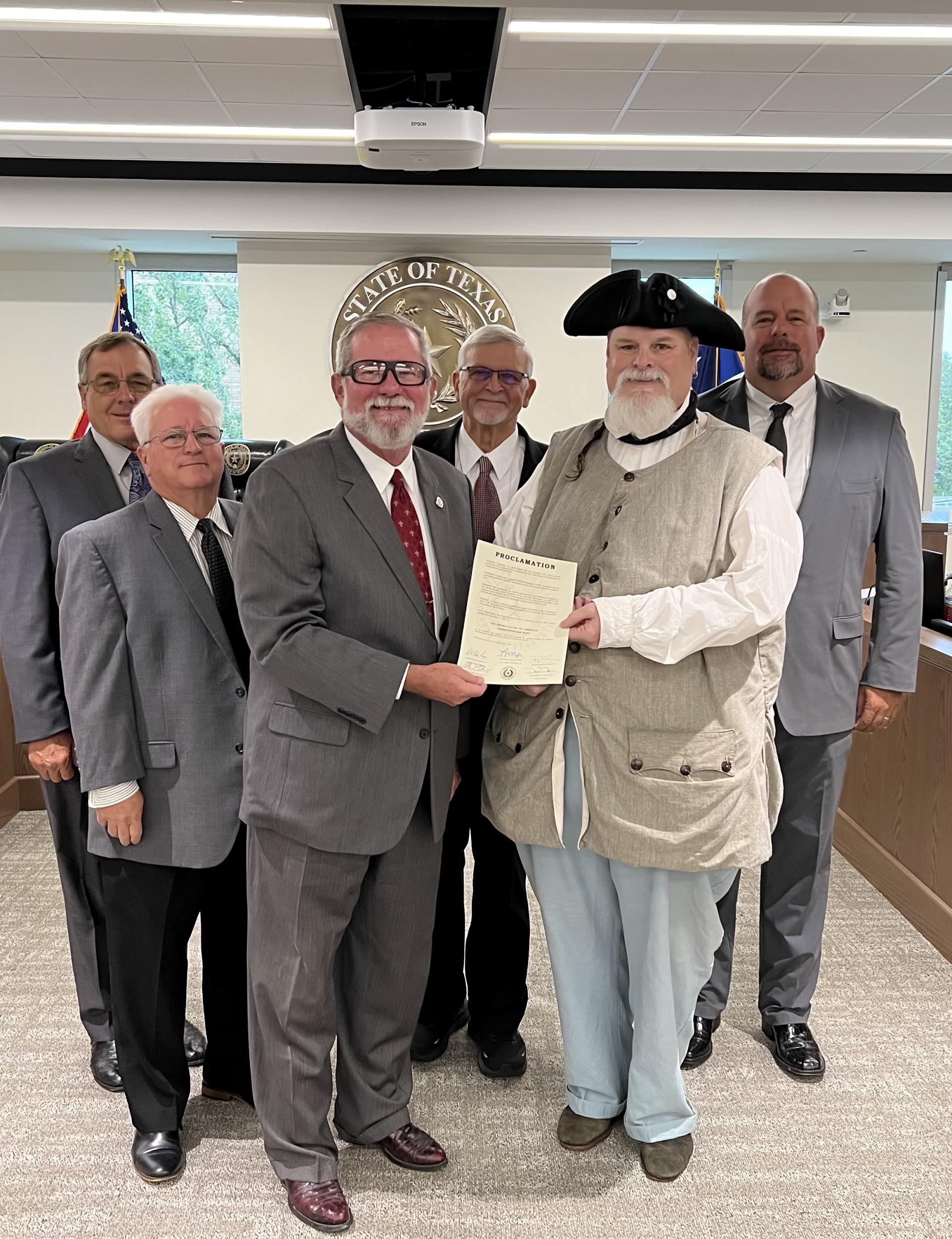 The Commissioners of Brazoria County posing for a picture holding a paper proclamation for the United States of Americas Constitution Day